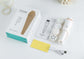4-in-1 rechargeable facial cleansing brush with accessories and packaging displayed on a countertop.