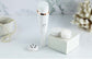 4-in-1 rechargeable facial cleansing brush with interchangeable heads and accessories on a clean marble surface.